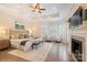 Relaxing main bedroom featuring hardwood floors, fireplace, bay window, and tray ceiling at 133 Crooked Branch Way, Troutman, NC 28166