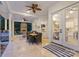 Inviting outdoor patio features a stone fireplace, ceiling fans, and seamless transition to the interior at 133 Crooked Branch Way, Troutman, NC 28166