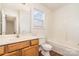 Bright bathroom includes a tub and shower combination, toilet, and vanity at 13514 Tartarian Ct, Charlotte, NC 28215
