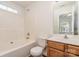 Bathroom with a combination tub and shower and vanity with a wood finish at 13514 Tartarian Ct, Charlotte, NC 28215