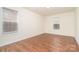 This bedroom has two windows for plenty of light and dark hardwood floors at 13514 Tartarian Ct, Charlotte, NC 28215