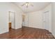 The bedroom includes two doors leading to the bathroom and closet and has warm hardwood floors at 13514 Tartarian Ct, Charlotte, NC 28215