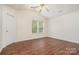 Spacious bedroom featuring a ceiling fan, neutral paint, and hardwood floors at 13514 Tartarian Ct, Charlotte, NC 28215