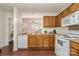 Functional kitchen with white appliances and a view into the adjacent living area at 13514 Tartarian Ct, Charlotte, NC 28215