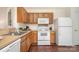 Efficient kitchen with wood cabinets, modern appliances, and durable countertop space at 13514 Tartarian Ct, Charlotte, NC 28215