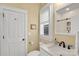 Bathroom showcasing a white vanity, stone countertop, and window with light at 140 Parkview St, Davidson, NC 28036