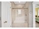 Bathroom showcasing a glass shower, soaking tub, and tiled walls at 140 Parkview St, Davidson, NC 28036