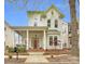 Charming two-story white home with a inviting front porch and a beautifully landscaped front yard at 140 Parkview St, Davidson, NC 28036