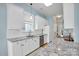 Galley kitchen featuring stainless appliances, granite countertops, and white cabinetry at 140 Parkview St, Davidson, NC 28036