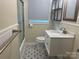 Bathroom featuring modern vanity, stylish floors, sleek fixtures, and shower with glass doors at 1401 Anderson St, Charlotte, NC 28205