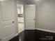 Bedroom with dark hardwood floors and access to kitchen and hallway at 1401 Anderson St, Charlotte, NC 28205
