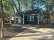 Quaint single-story home featuring dark siding, white trim, and a concrete driveway at 1401 Anderson St, Charlotte, NC 28205