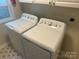Laundry room features modern washer and dryer, bright natural light, and stylish flooring at 1401 Anderson St, Charlotte, NC 28205