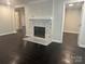 Cozy living room with decorative fireplace and dark hardwood floors at 1401 Anderson St, Charlotte, NC 28205