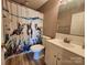 Bathroom featuring an updated vanity, toilet, and a whimsical shower curtain at 14522 Waterside Dr, Charlotte, NC 28278