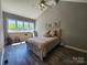 Bright bedroom with a vaulted ceiling, large window and luxury vinyl plank flooring at 14522 Waterside Dr, Charlotte, NC 28278