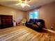 Cozy bedroom featuring a dark brown leather sofa and a ceiling fan at 14522 Waterside Dr, Charlotte, NC 28278