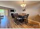 Open concept dining area flowing into the living room with hardwood floors and natural light at 14522 Waterside Dr, Charlotte, NC 28278
