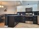 Well-appointed kitchen featuring sleek black cabinetry, granite counters, and modern appliances at 14522 Waterside Dr, Charlotte, NC 28278