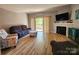 Cozy living room featuring a fireplace, plush seating, and access to a balcony at 14522 Waterside Dr, Charlotte, NC 28278