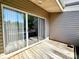 A bright patio features a sliding glass door, wood floors, and vinyl siding at 14522 Waterside Dr, Charlotte, NC 28278