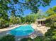 Inviting community pool features lounge chairs, well-maintained landscaping, and a serene atmosphere at 14522 Waterside Dr, Charlotte, NC 28278