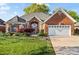 Beautiful brick home featuring an attached two-car garage and a well-maintained front lawn at 1511 Elkhart Cir, Gaston, NC 28054