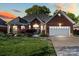 Beautiful brick home featuring an attached two-car garage and a well-maintained front lawn at 1511 Elkhart Cir, Gaston, NC 28054