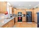 Well-lit kitchen with granite countertops, stainless steel appliances, and beautiful wood cabinetry at 1511 Elkhart Cir, Gaston, NC 28054