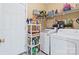 Functional laundry room with modern appliances, shelving, and convenient storage solutions at 1511 Elkhart Cir, Gaston, NC 28054