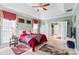 Bright main bedroom with tray ceiling, carpet floors, and access to an en-suite bathroom at 1511 Elkhart Cir, Gaston, NC 28054