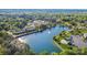 High aerial view showcasing a picturesque lake surrounded by lush green trees and well-maintained townhouse communities at 158 Water Oak Dr, Pineville, NC 28134