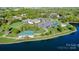 Community amenities view shows clubhouse, pool, ample parking, and lush landscaping by the water at 158 Water Oak Dr, Pineville, NC 28134
