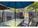 Cozy backyard patio with a large table, chairs, privacy fence, and hanging plants at 158 Water Oak Dr, Pineville, NC 28134