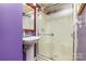 Bathroom featuring shower stall with glass doors, pedestal sink and decorative mirror at 158 Water Oak Dr, Pineville, NC 28134