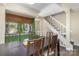 Open dining area connected to the kitchen with stairs leading up creating a cozy atmosphere at 158 Water Oak Dr, Pineville, NC 28134