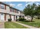 Townhouse exteriors featuring light beige siding, white doors, brown shutters, green lawns, and beautiful landscaping at 158 Water Oak Dr, Pineville, NC 28134