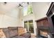 Cozy living room features a fireplace, comfortable seating, and ample natural light from the sliding glass doors at 158 Water Oak Dr, Pineville, NC 28134