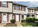 Well-maintained townhome with tan siding, contrasting shutters, and manicured lawn at 158 Water Oak Dr, Pineville, NC 28134