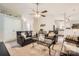 Cozy living room featuring comfortable leather furniture, ceiling fan, and open access to the kitchen at 1807 Oakdale Green Dr, Charlotte, NC 28216