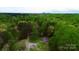 Gorgeous aerial view of the land with a cozy cabin at 181 Canipe Rd, Dallas, NC 28034