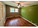 Bedroom featuring a ceiling fan, wood-look floors, and ample natural light at 181 Canipe Rd, Dallas, NC 28034