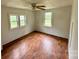 A sunny bedroom with wood-look floors, a ceiling fan, and two windows at 181 Canipe Rd, Dallas, NC 28034