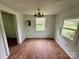 Dining area with wood-look floors, two windows and a vintage light fixture at 181 Canipe Rd, Dallas, NC 28034
