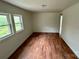 Bright living room with wood-look floors and large windows offering natural light at 181 Canipe Rd, Dallas, NC 28034