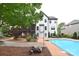 Expansive backyard with a large in-ground pool, a screened-in porch, and lush landscaping at 1811 Robbins Meadows Dr, Waxhaw, NC 28173