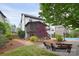 Exterior view of backyard with pool, landscaping, screened porch, and fire pit area at 1811 Robbins Meadows Dr, Waxhaw, NC 28173