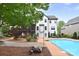 Expansive backyard view featuring a pool, deck, and well-maintained landscaping, creating an ideal outdoor living space at 1811 Robbins Meadows Dr, Waxhaw, NC 28173
