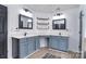 Well-lit bathroom featuring double sinks, wood shelves, and modern fixtures at 1811 Robbins Meadows Dr, Waxhaw, NC 28173