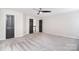 Spacious bedroom with gray carpet, neutral walls, ceiling fan, and doorway views to a second floor at 1811 Robbins Meadows Dr, Waxhaw, NC 28173